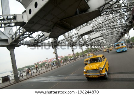 KOLKATA, INDIA - August 16 :taxi on  the Howrah Bridge on August 16, 2010. Howrah Bridge is a famous landmark in the city of Calcutta / Kolkata, India.