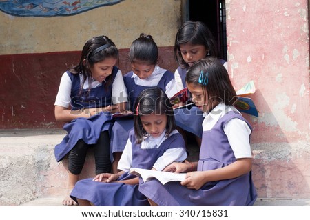 ALANGAON, MAHARASHTRA, INDIA - February 22, 2014: Happy Indian rural girl at their school, Alangaon, Amravati , Maharashtra, India