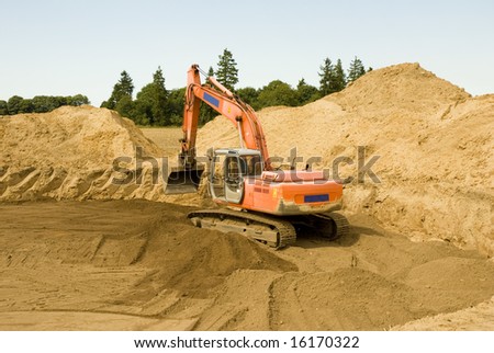 Digger excavator at work - excavation for the wind turbine