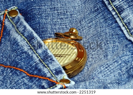 golden pocket watch in back pocket of jean