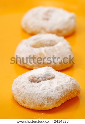 Greek traditional cookies in yellow background ..extreme closeup you can see the sugar texture