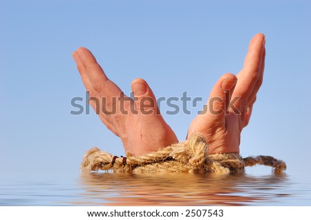 Close up of female hands tied in a rope on the sea (concept for slave or cast-away theme)