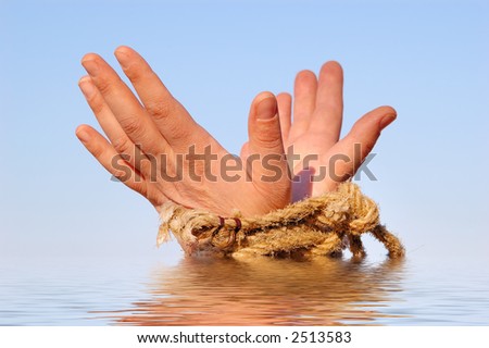 Close up of female hands tied in a rope on the sea (concept for slave or cast-away theme)