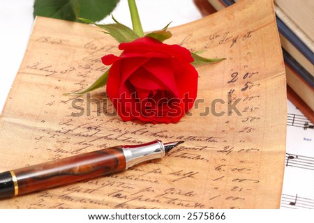 red silky rose with vintage pen and letter