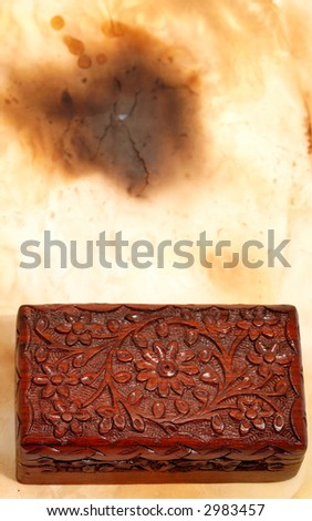 wooden old box on aged paper background