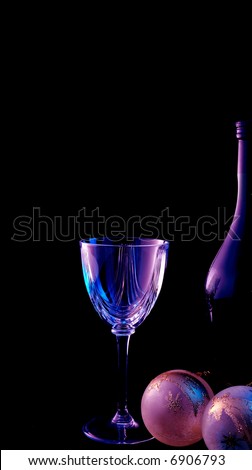 glass and a bottle of red wine lit with small blue and purple lights give a mood romantic feeling