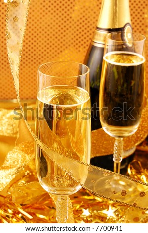 Champagne bottle and glasses  on gold background
