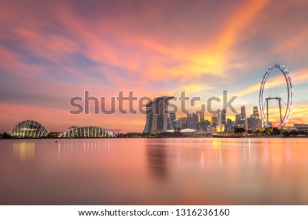 Singapore Skyline with illuminations. Singapore`s business district, marina bay sand and the garden by the bay on sunset.