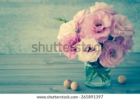 Gentle Flowers in a glass vase with copy space - vintage style still life, toned