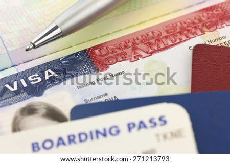 USA Visa, passports, boarding pass and pen - foreign travel background