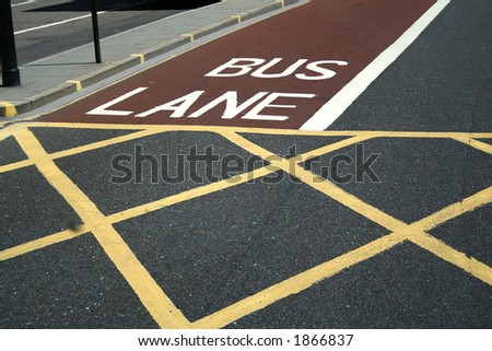 London. Road in  the city. Sectoring for buses and pedestrians. Red, white and yellow lines.