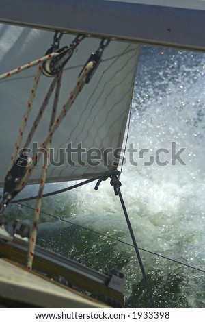 The large waves cover a sailing yacht. Sails and rigging.