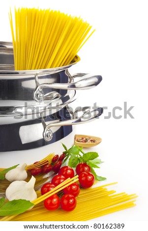 Italian cooking / pasta, tomatoes, basil, garlic and saucepan / focus on the foreground