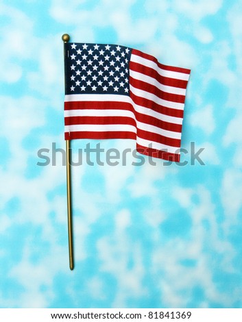 Ripples in US Flag on Pole isolated on blue sky background