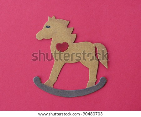 Handmade Wooden Rocking Horse Cutout isolated on red background
