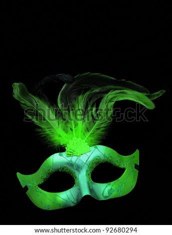 Fancy Green and Blue Feathered Mask isolated on a black velvet background