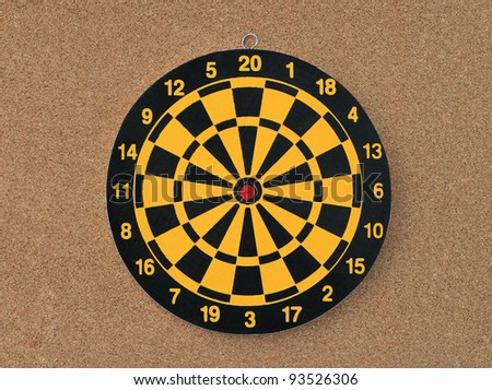 New Colorful Dart board isolated on cork board background
