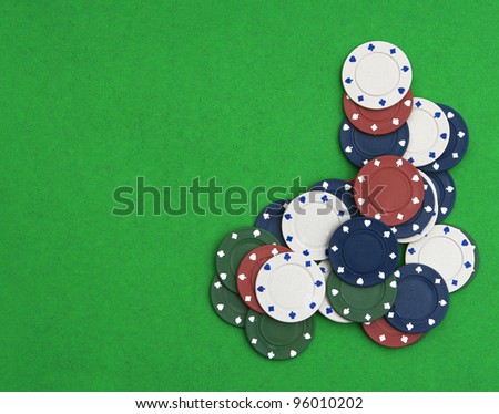 Poker chips on a green table background