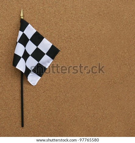 Black and White Finish Line Checkered Flag isolated on cork board background with room for your text