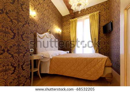 Elegant double bed in a hotel room,  in baroque style