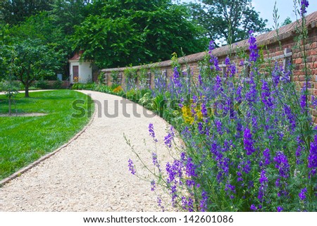 Path leads past a row of flowers in George Washington\'s Mount Vernon flower gardens.