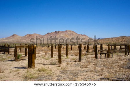 Wooden fence posts are all that remain of an abandoned farm in the California desert.