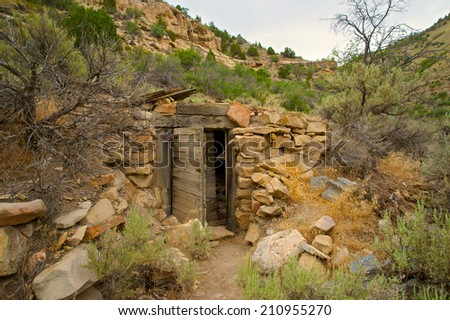 Abandoned and dilapidated remains of an old gold miner\'s home in the vast western wilderness.