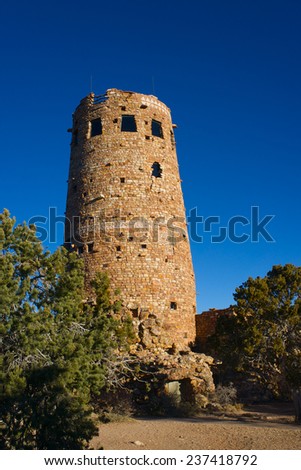 Sun shines off the walls of stone in the Desert Watchtower overlooking the Grand Canyon National Park.