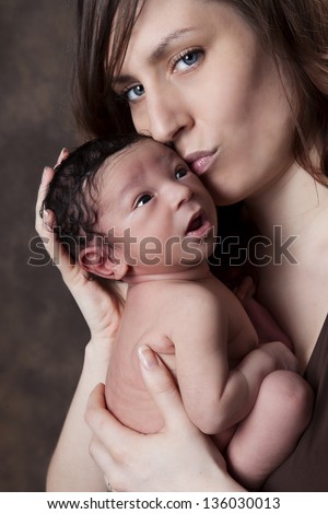 Sweet Kisses.  Caucasian mother kissing her biracial baby.