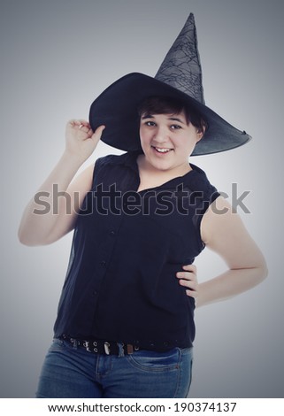 Teen wearing a witches hat.