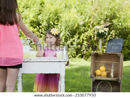Lemonade Stand.  Adorable young girl selling lemonade.