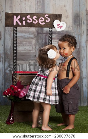 The Kissing booth.  Two adorable toddlers at a kissing booth.