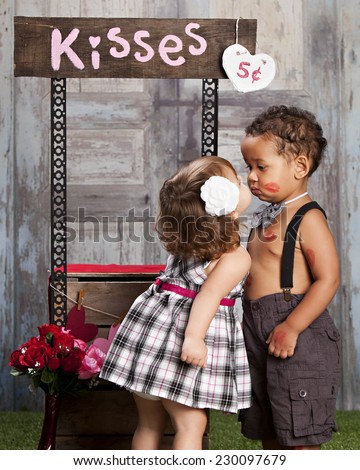 The Kissing booth.  Two adorable toddlers at a kissing booth.