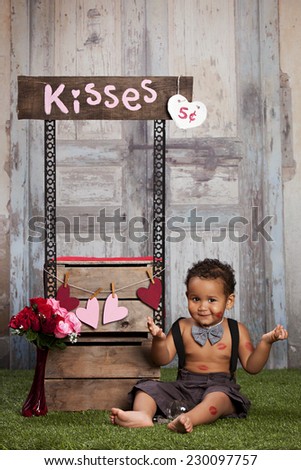 The kissing booth.  Adorable toddler running a kissing booth.