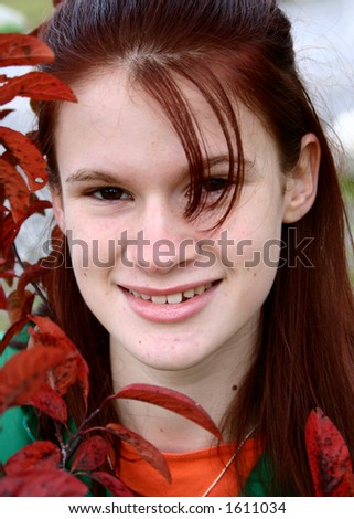 Young attractive woman framed by fall foliage
