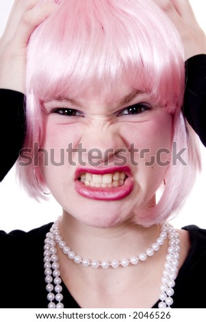stock photo Frustrated teen wearing a pink wig and a string of pearls
