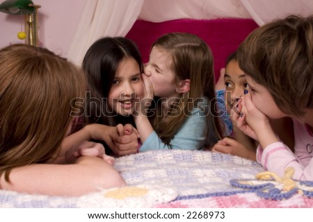 Friends telling secrets at a slumber party.
