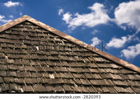 Roof top of old building.  Beautiful blue sky.