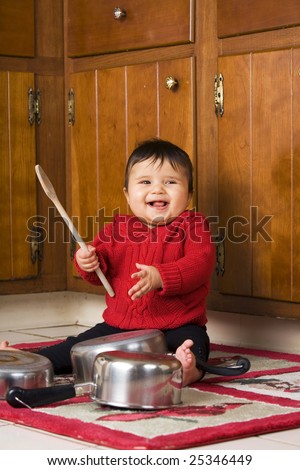 stock-photo-baby-girl-delighted-with-the-noise-she-s-making-banging-on-pots-and-pans-with-a-wooden-spoon-25346449.jpg