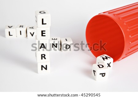 Letter cubes formed crossword style to read - Live and Learn.  (Focus on the word LEARN)