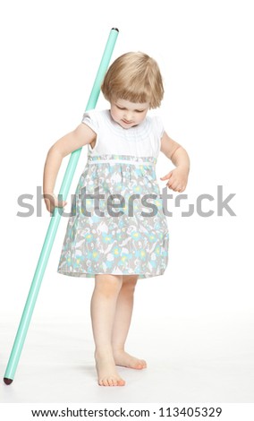 Little playful girl in dress holding sport stick - full length portrait on white background
