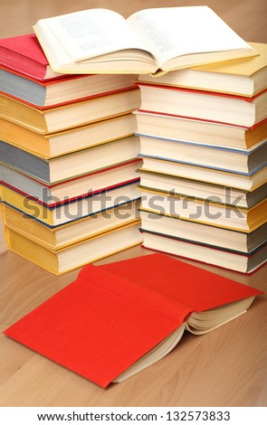 Many stacked books on the floor