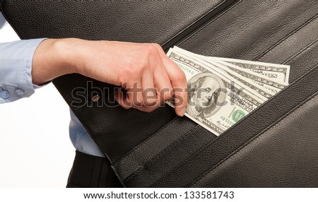 Hand taking money out of leather briefcase
