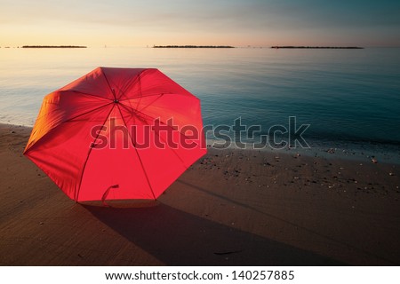 Tranquil Mediterranean morning seashore with beach umbrella