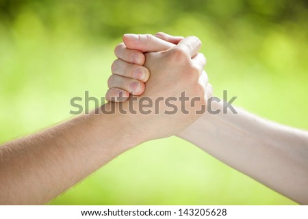 Arm wrestling on light green background