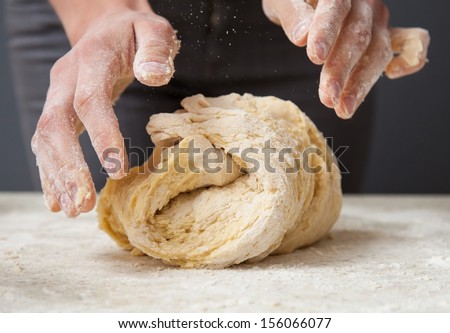 Woman\'S Hands Knead Dough On A Table