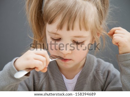 Pretty little girl eating - closeup shot