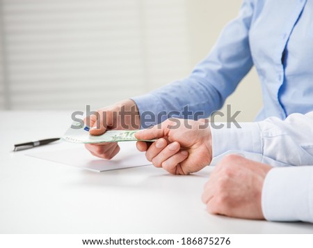 Business people exchanging euro banknotes - closeup shot of hands