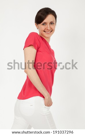 Portrait of casual smiling young woman posing on neutral background
