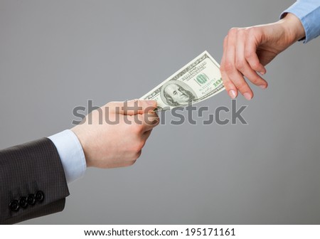 Business people hands exchanging money, closeup shot on grey background